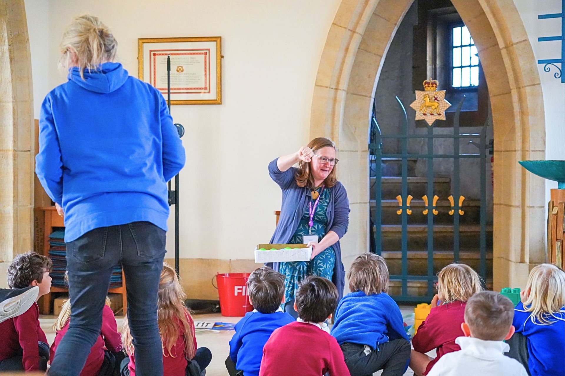 Volunteer and teacher leading an activity in a church