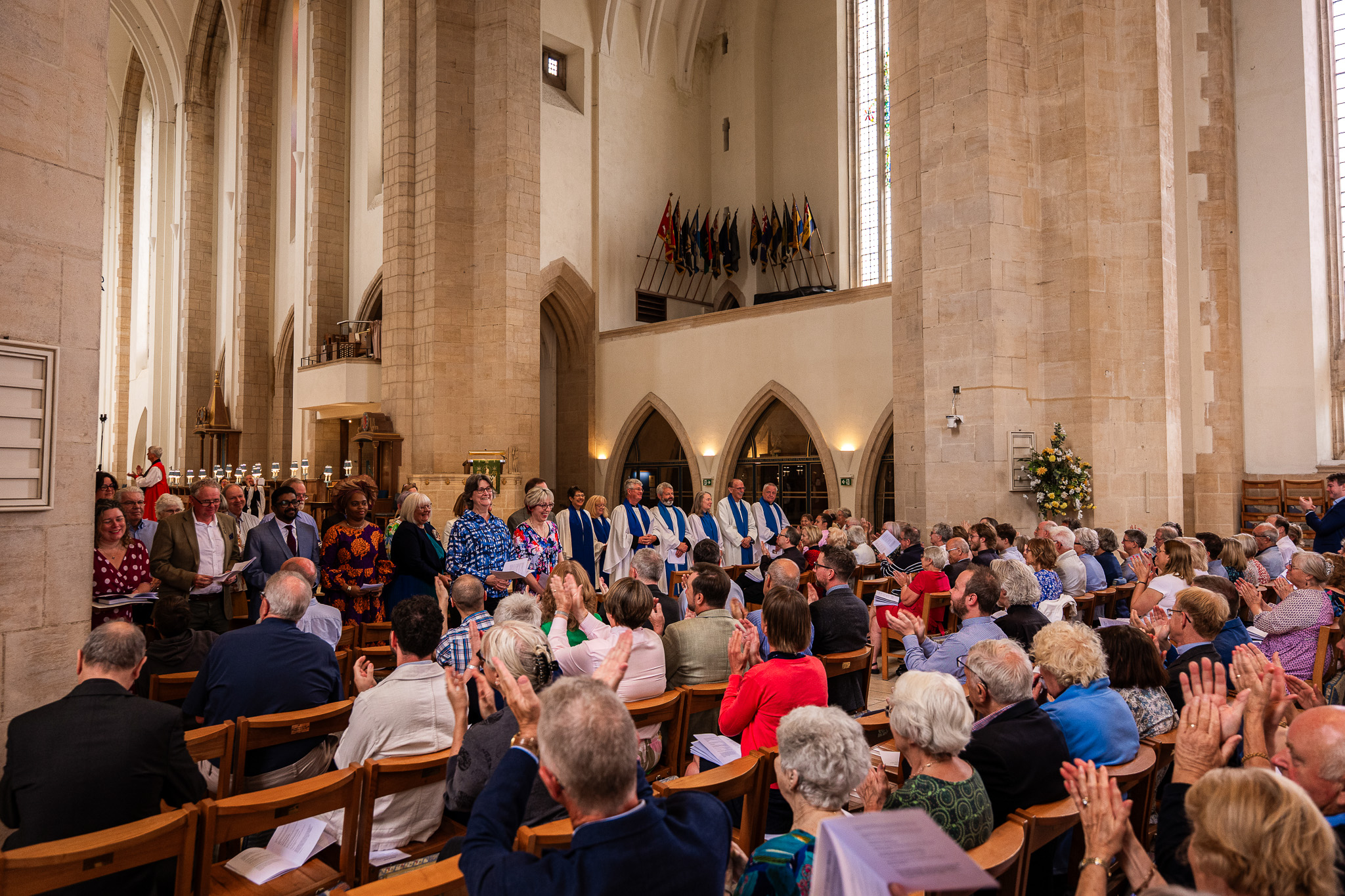 Lay Ministers stand to face the congregation in Guildford Cathedral to be celebrated as those present applaud them.