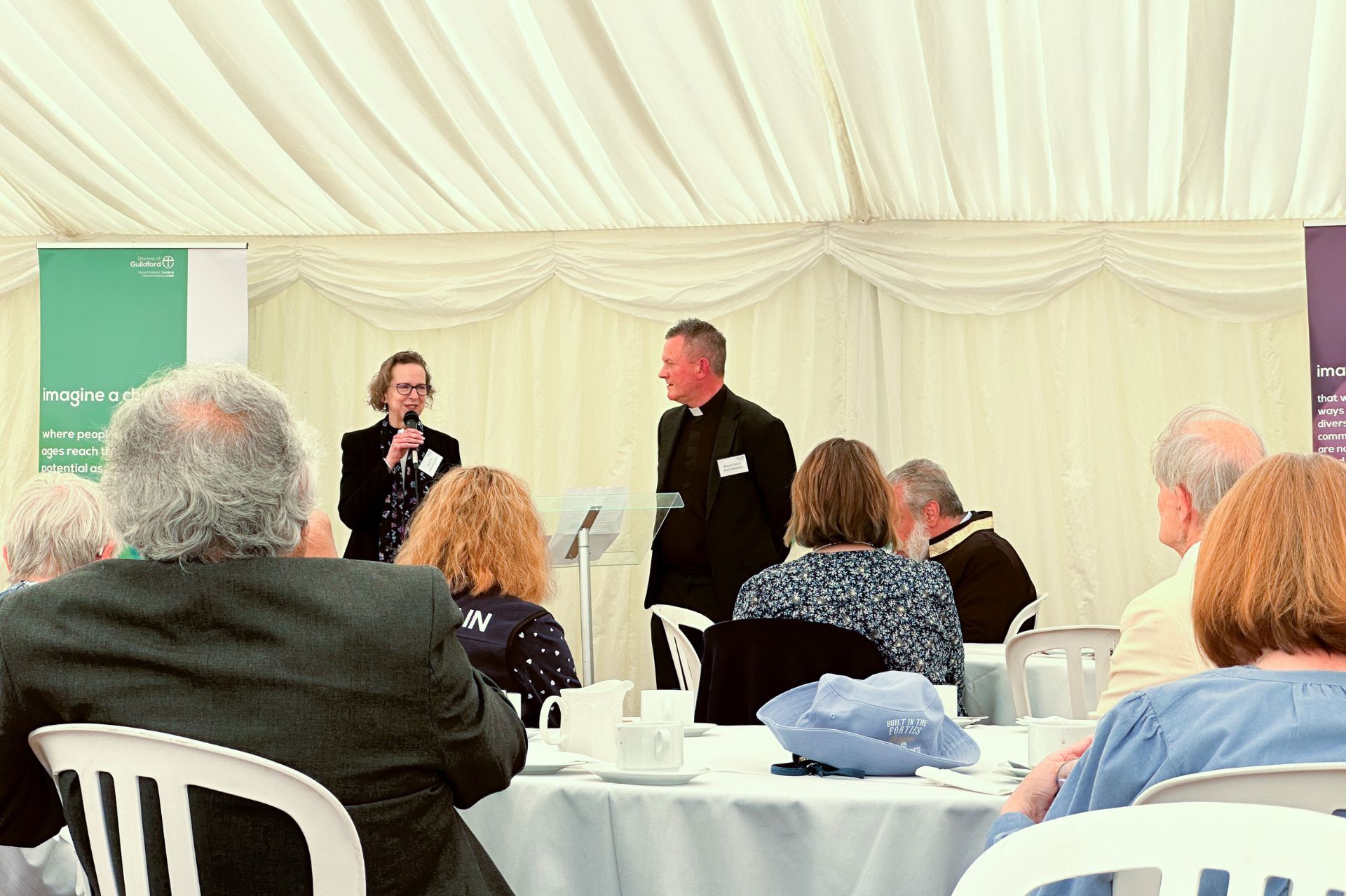 Mark & Anna Paulson address the attendees of the Interfaith gathering at the Bishop's Tent Week