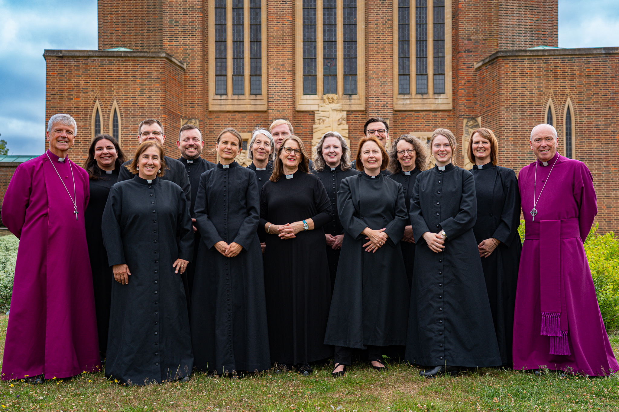 The 10 women and 5 men who became priests in the Diocese of Guildford in 2025 stand with Bishop Andrew and Bishop Paul outside Guildford Cathedral