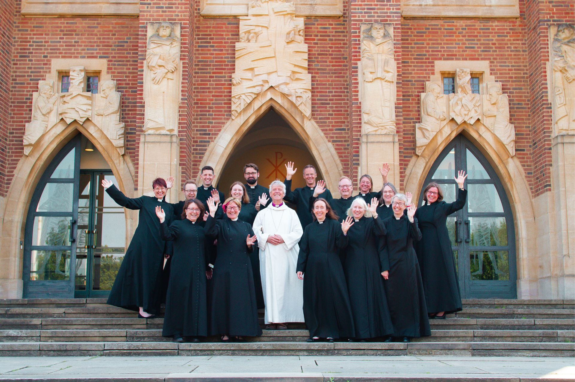 The group of priests being ordained in 2024 on the steps of Guildford Cathedral with the Bishop of Guildford