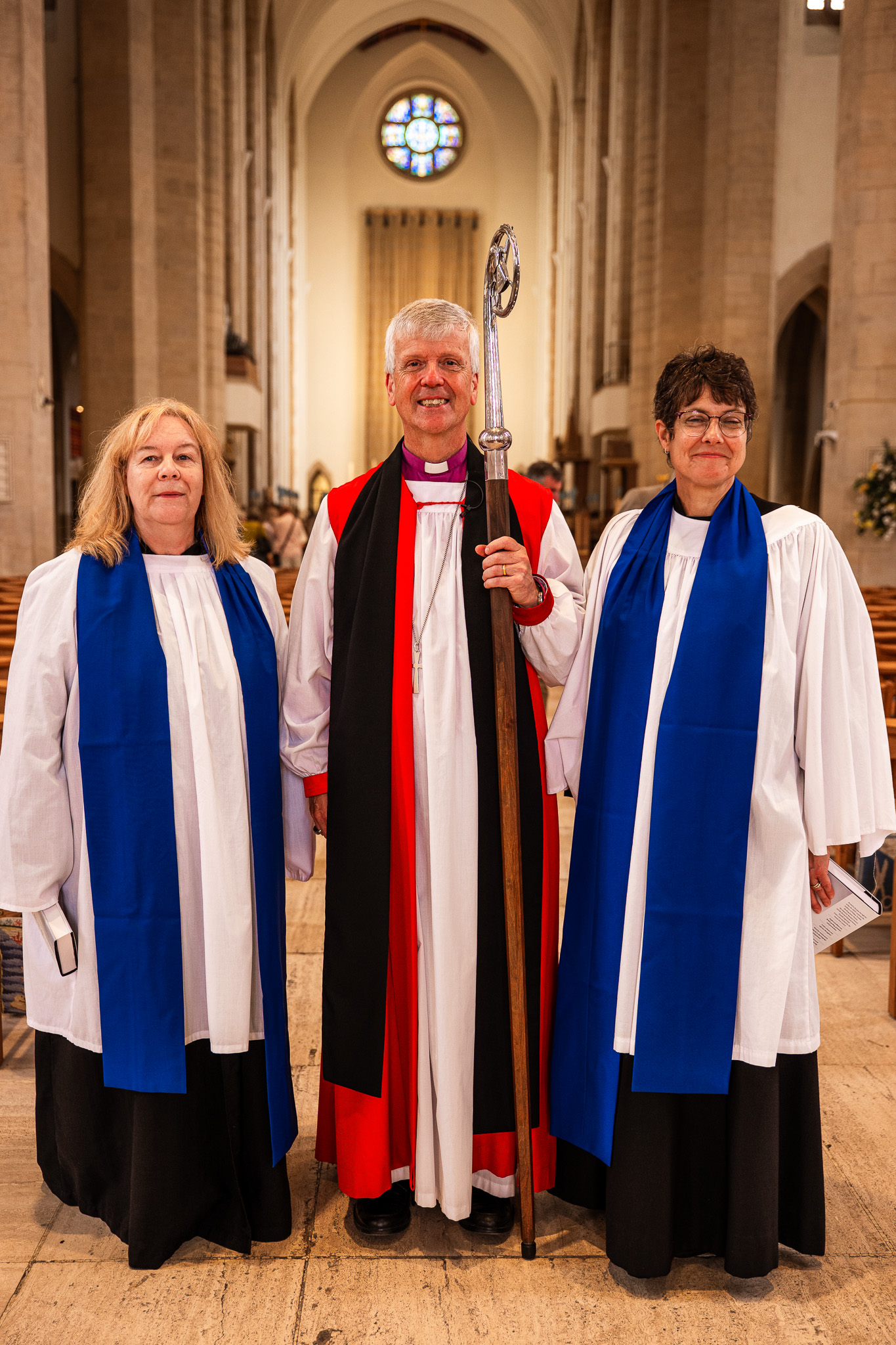 Sara and Jo robed with Bishop Andrew Watson in Guildford Cathedral