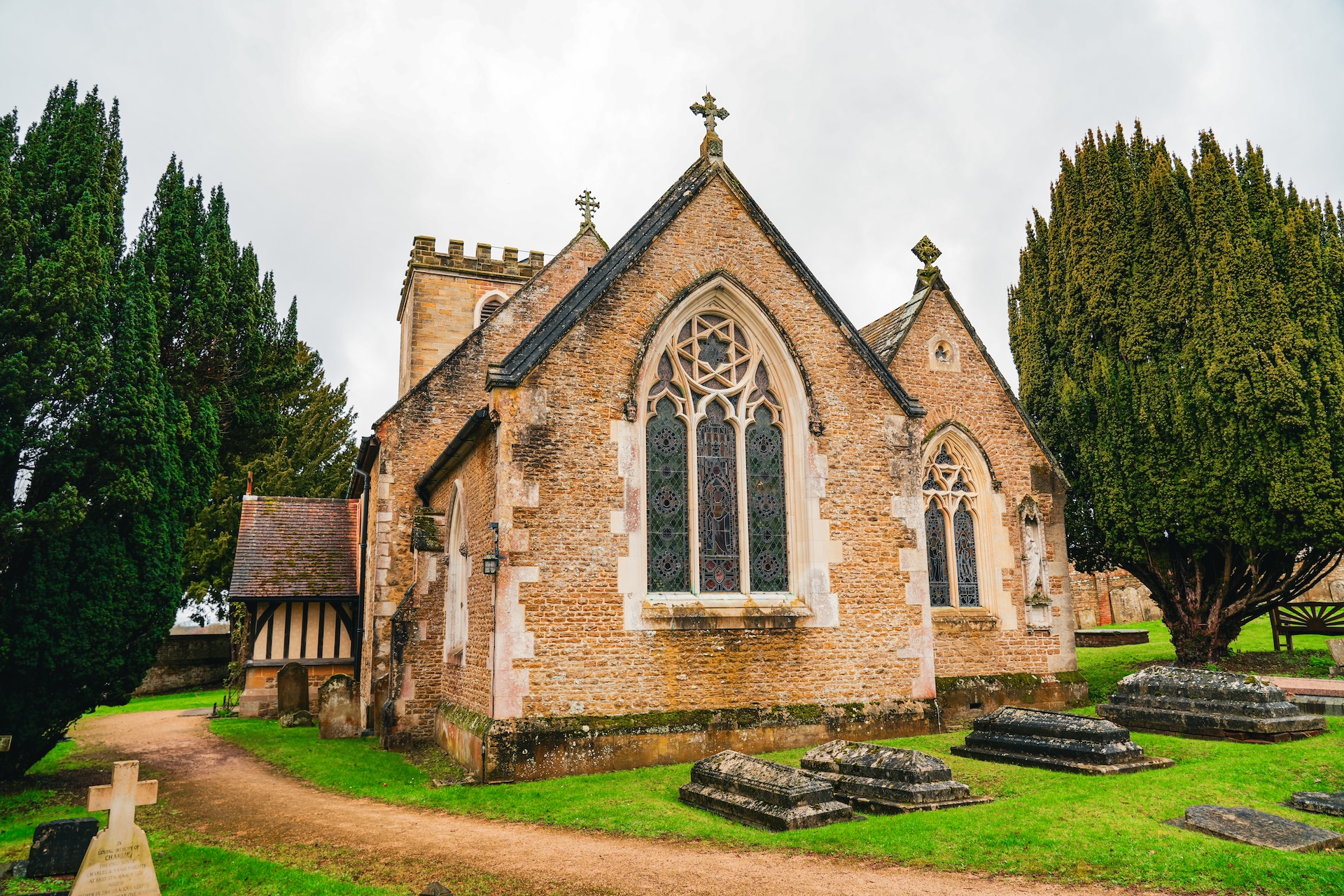 Exterior of a rural church and graveyard in the sunshine